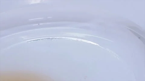 Close Up Of Adding Dried Yeast Granules Into Water, UK Stock Footage 138346859