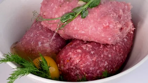 Close-up of adding eggs to fresh minced meat, spices Vidéo 146645338