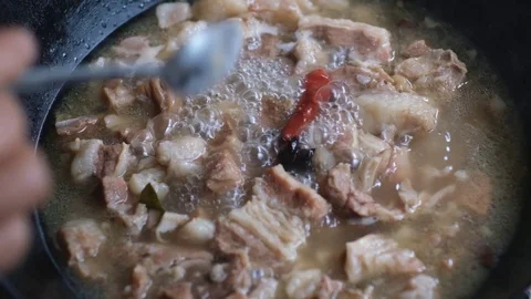 Close up of adding salt to stewing beef  in Chinese cooking style, slow motion Stock Footage 114644050