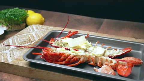 Close-up of adding sliced parmesan cheese on a cooked lobster before grilling. Stock Footage 146343668