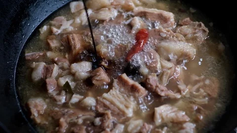 Close up of adding soy sauce to stewing beef , slow motion Stock Footage 114644309