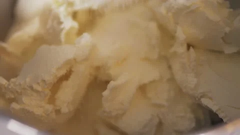 Close-up of adding sugar to the cream in a planetary mixer. Video stock 147915668