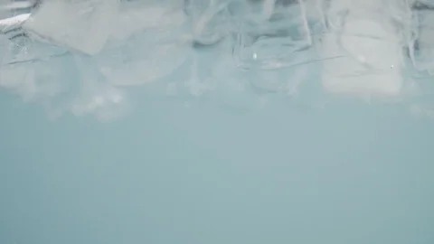 Close-up of adding yellow pigment to an aquarium with water. Slow motion video Stock Footage 125067240
