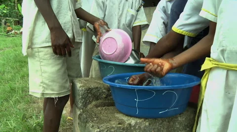 CLOSE UP: ADEISO BOY STUDENTS WASH DISHES Stock Footage 58069645
