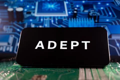 Close up of Adept AI logo on device with circuit board background. Toronto, Stock Photos
