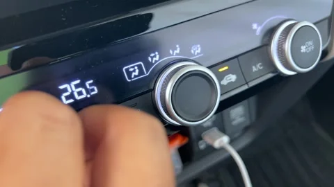 Close up of adjusting car climate control knob on vehicle dashboard Stock Footage 341433254