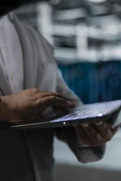 Close up of admin in data center typing on laptop keyboard, writing code Stock Photos