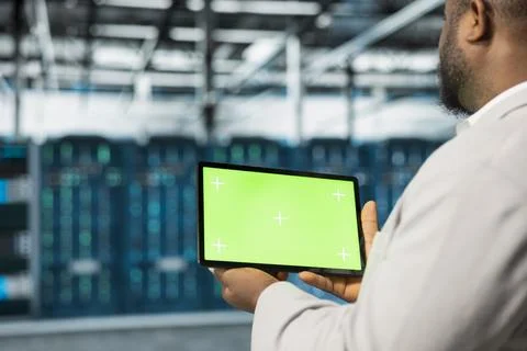 Close up of admin in data center using green screen tablet to manage systems Stock Photos