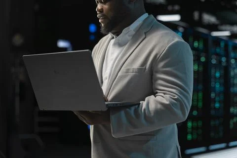Close up of admin in server farm managing infrastructure systems Stock-Fotos