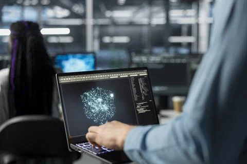 Close up of admin using laptop in data center, optimizing hardware for AI tasks Foto stock