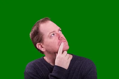 Close up adult man looking up thinking on green screen Stock Photos
