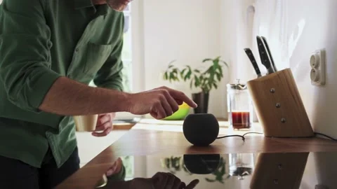 Close-up of adult man using smart speaker at kitchen Stock Footage 231370267