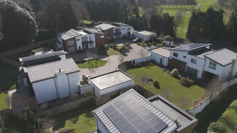 Close aerial of angular grey-and-white houses with integrated garages and large Vídeos de archivo 310589839