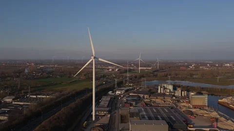 Close aerial approach to single wind turbine in warm evening light Stock Footage 335651661