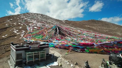 Close aerial around prayer flags beside a small Tibetan hut Stock Footage 345883062