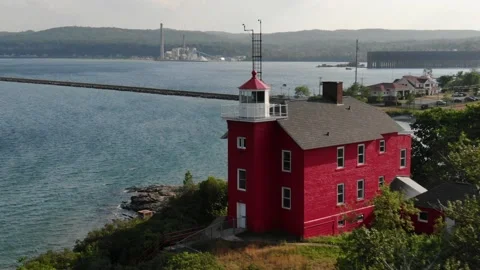Close up aerial around red light house in Marquette Michigan in summer Stock Footage 207652190