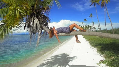 Close up aerial drone quad copter footage of beach woman wearing virtual reality Stock Footage 199622037
