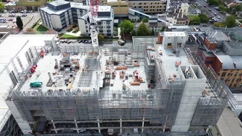 Close aerial drone view of active multi-storey construction project Stock Footage 332786689