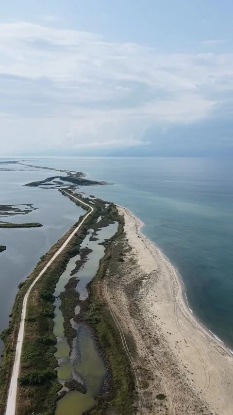 Close up aerial drone view of coastal spit, lagoons and fish farm ponds in Kaval 動画素材 342105576