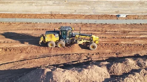Close aerial of a grader working to level a construction site Stock Footage 278340248