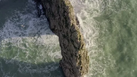 Close aerial over Durdle Door limestone arch on the Jurassic coast in Dorset Stock Footage 251052553