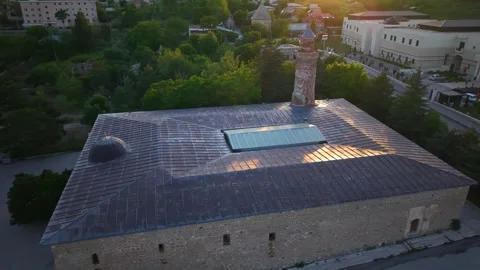 Close Aerial Pullback Revealing Historic Mosque Minaret at Golden Sunset Stock Footage 339685614