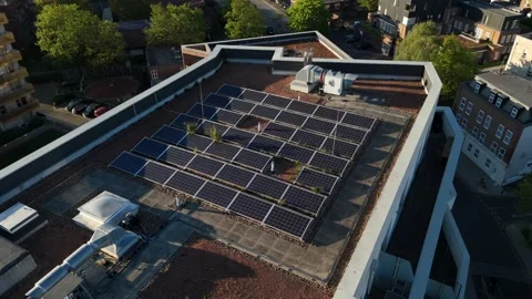 Close Aerial Shot Rooftop Solar Panels on Urban Building in England Vídeo Stock 334167946