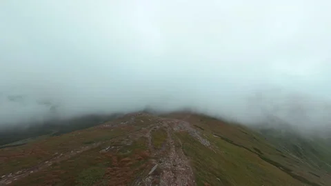 Close up aerial top of drone view of green mountains with fog. Beautiful Stock Footage 197486042