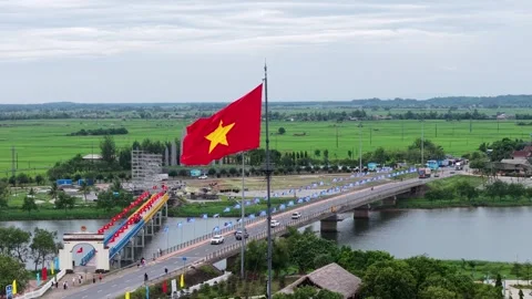 Close aerial of Vietnamese flag over Hien Luong Bridge 4K Stock Footage 339865262