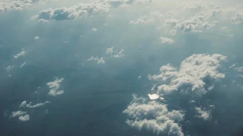 Close up aerial view above clouds from airplane window with blue sky landscape Stock Footage 138633610