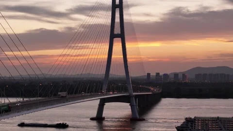 Close aerial view of cable stayed bridge at colorful sunset in China Stock Footage 337675040