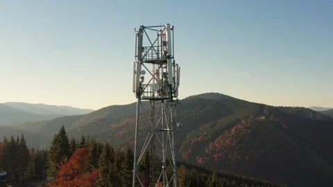 Close-up aerial view of a cell tower carrying antennas of cellular networks Video stock 236455198