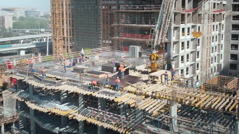 Close up aerial view to the construction works on the top of a skyscraper. Stock Footage 181119237