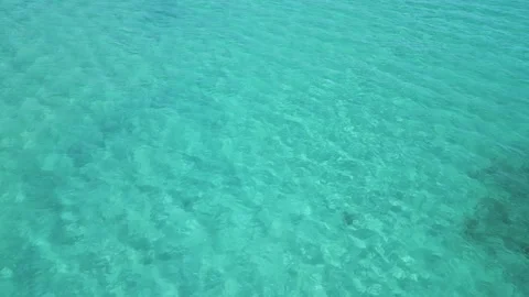 Close-up aerial view of crystal-clear turquoise sea water with visible textures Stock Footage 314277216
