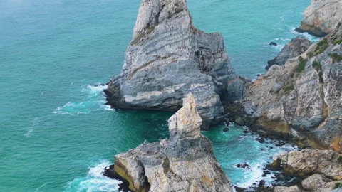 Close-up aerial view of dramatic sea stacks and rugged cliffs at Cabo da Roca Stock Footage 322006304