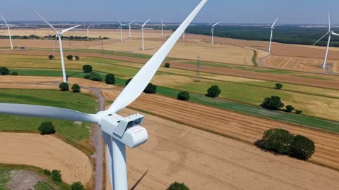 Close-Up Aerial View of Large Onshore Wind Farm and Renewable Power Turbines Stock Footage 341475579
