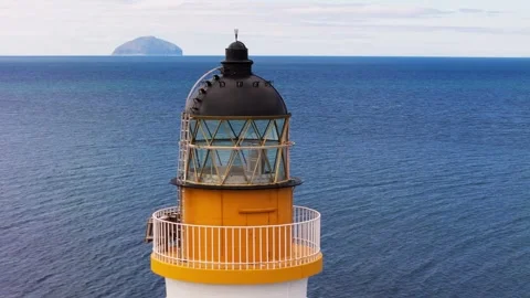 Close-up Aerial View of Lighthouse Beacon with Ailsa Craig in Background Vídeos de archivo 333767858