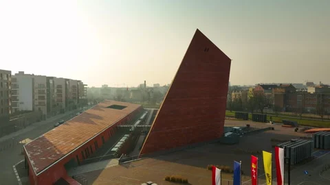 Close-up aerial view of a modern angular red-brick architectural landmark in an Video stock 304599148