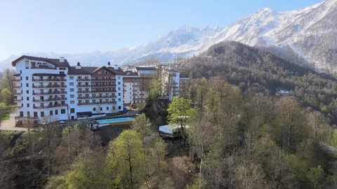 Close-up aerial view of a mountain hotel resort in spring Stock Footage 337544990