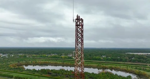 Close-up aerial view of the old abandoned radio tower on a cloudy afternoon Stock Footage 318199721
