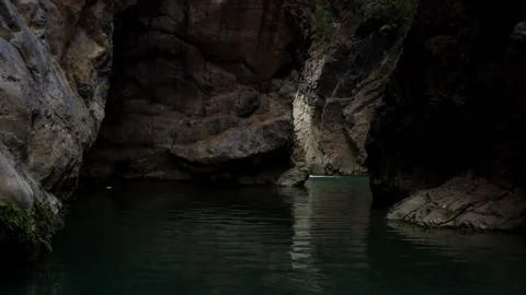 Close aerial view of a river in between the mountains Stock Footage 172058876