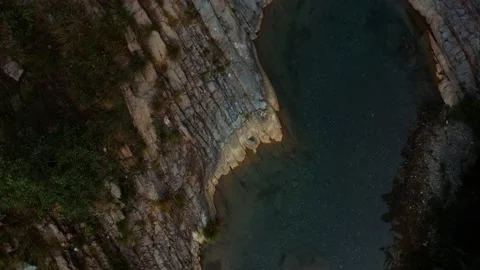 Close aerial view of a river in between the mountains Stock Footage 172310541