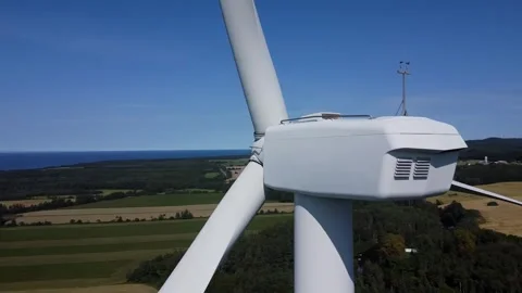 Close aerial view rotating around the head of a huge wind turbine. Stock Footage 303677990