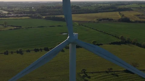 Close aerial view of rotating wind turbine over countryside fields Stock Footage 333935313