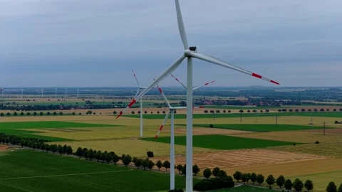 Close Aerial View of Rotating Wind Turbines Over Farmland Stock Footage 340137298
