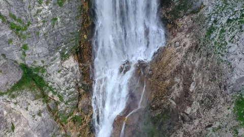 Close aerial view of waterfall flowing into turquoise pool, Slovenia Stock Footage 325218158