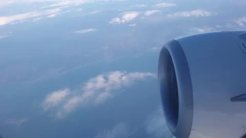 Close-up of aeroplane engine in the air while flying above clouds Stock Footage 205804747