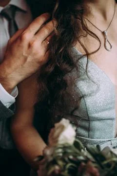 Close up of affectionate man touching female face with gentleness. Lovers are Stock Photos