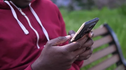 Close up of African American hands using smartphone for messaging Stock Footage 332418467