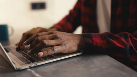 Close-up of an African American programmer typing on a laptop, distance work Stock-Footage 304431111